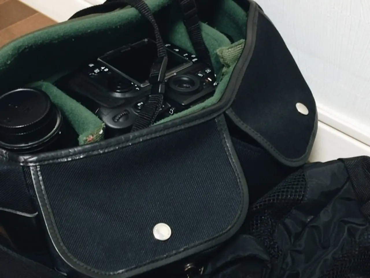 Here in this picture we can see black colored bags present on the floor over there and in that we...