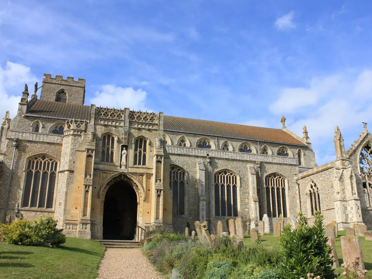 In this image I can see a fort , in front of the fort I can see grass and bushes and plants ,at the...