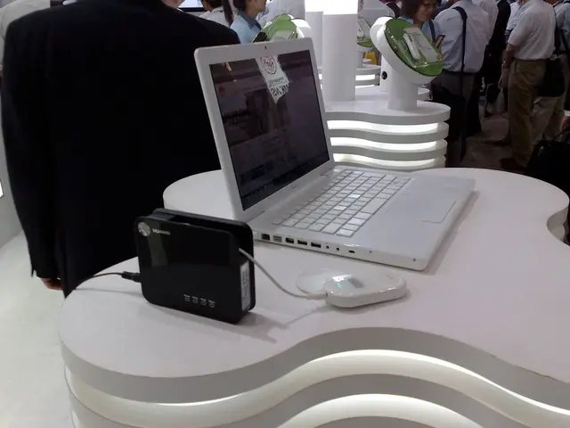 In this picture we can see a laptop and few devices on the platform and in the background we can...