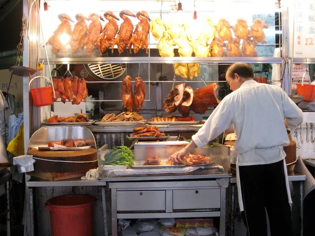 Here we can see a person holding food. There is a bin. Here we can see track, meet, buckets, and...