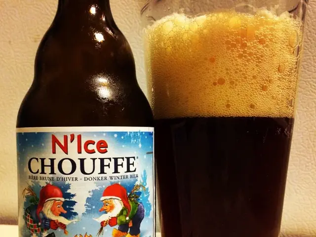 In this image we can see a beer bottle and a glass with beer in it on the white color surface.