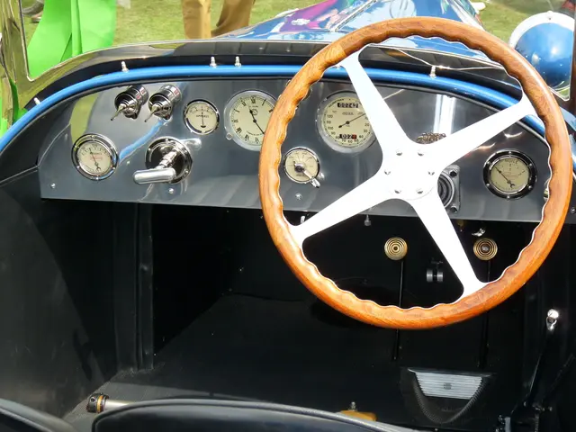 In this picture we can see a steering, speedometer, meter gauges, some parts of a vehicle and in...