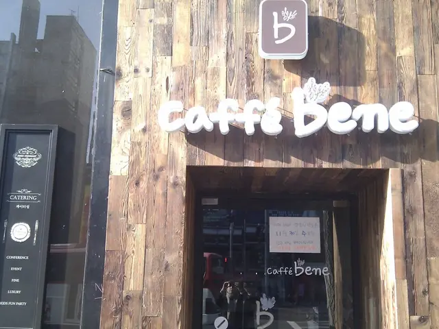 In this image, at the right side there is a shop, on that show there is CAFFE BENES is written, at...